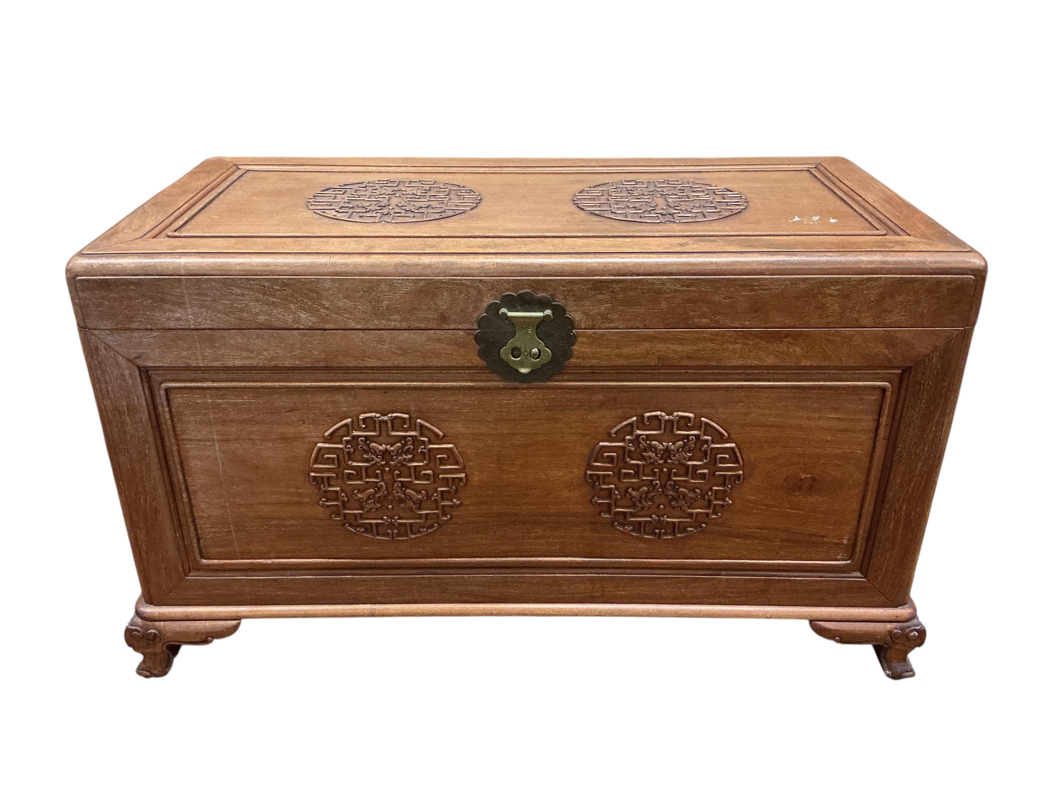 A Chinese carved camphor wood trunk, width 100cm, depth 54cm, height 59cm